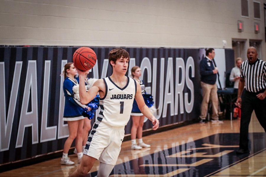 Senior Brooks Jahnke tosses the ball back to the referee after a play.