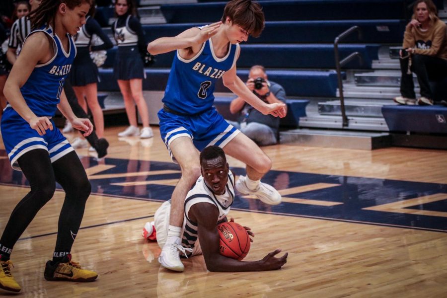 Diving underneath a Gardner Edgerton player, senior Nen Matlock steals the ball.