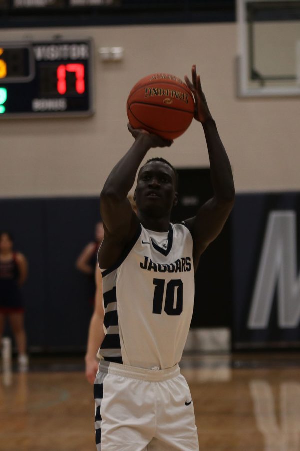 Aiming to earn a point for the team, senior Nen Matlock shoots a free throw.
