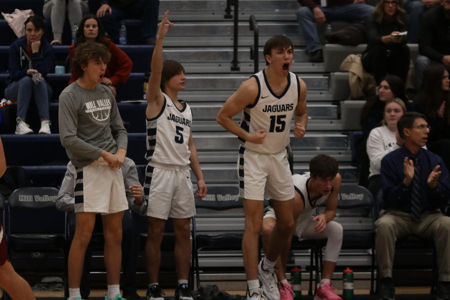 Celebrating after a three-pointer, freshman Reece Reidel, junior Kael Drummond, and senior Marko Skavo cheer for their teammate.
