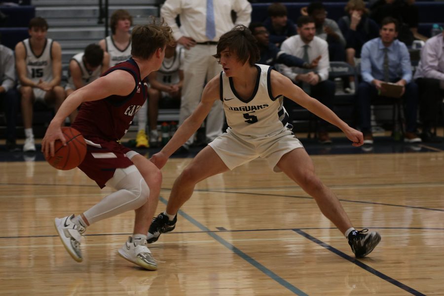 Sliding his feet, junior Kael Drummond plays full court defense on the Eudora point guard. 
