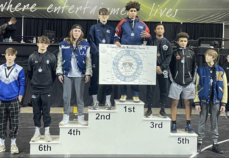 Junior Dillon Cooper stands on the podium after placing 2nd in the 126-pound weight class.