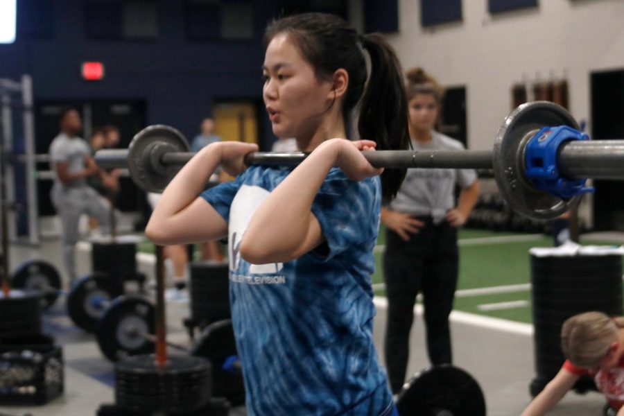 Letting out a breath, senior Sophia Chang gets prepared to lift