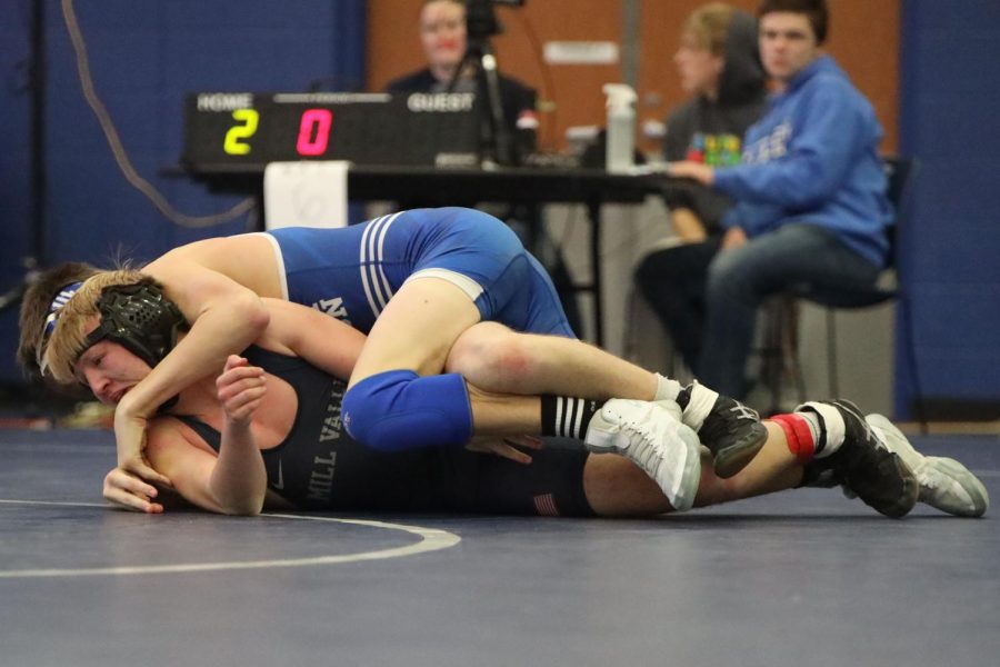 Being held down by his opponent, junior Robert Hickman makes an attempt to break free.
