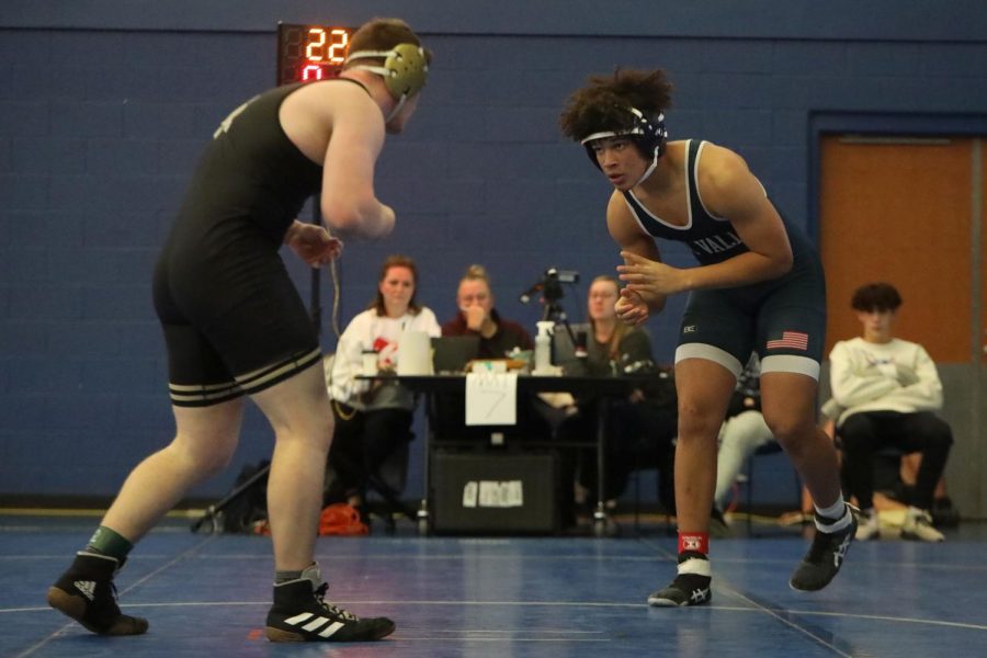 Staring at the other wrestler, freshman MJ Wash prepares to take his opponent down.
