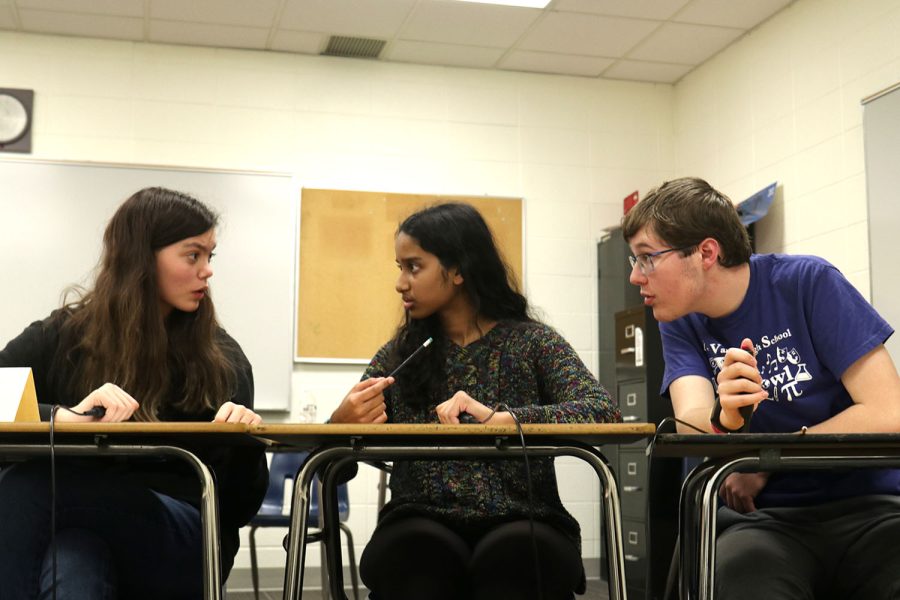 Freshman Ian Weatherman proposes his answer and quickly verifies with his teammates to answer before their opponents.