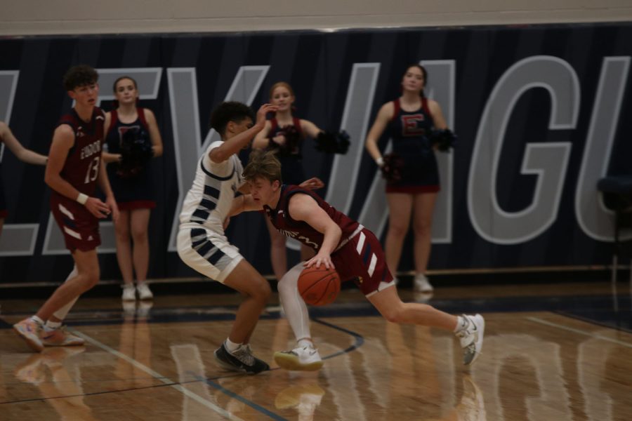 Sliding his feet, senior Jameson Fisher plays tight defense on the opponent
