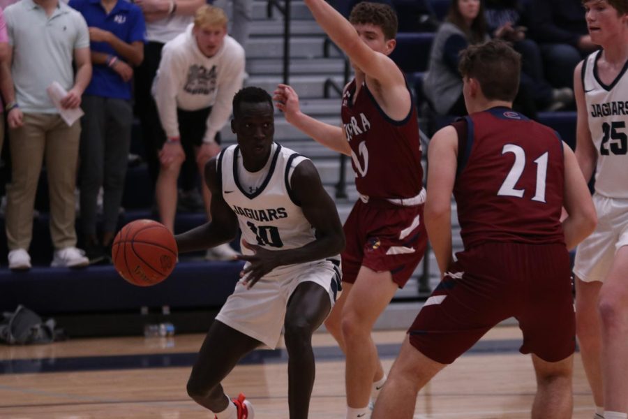 Senior Nen Matlock looks for an open to pass the ball to his teammate Tuesday, Dec. 6.