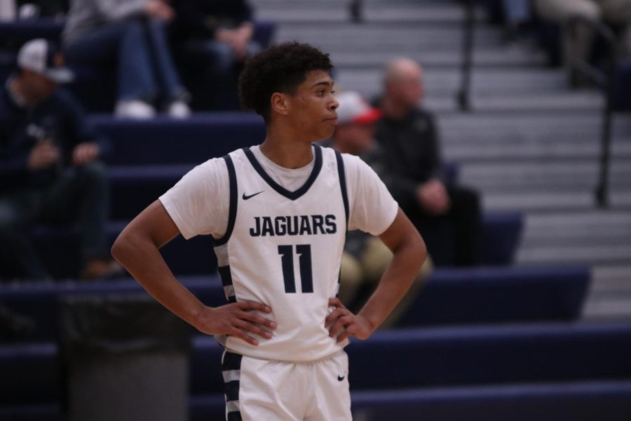 Focusing on the game, senior Jameson Fisher stands to catch his breath on the court. 