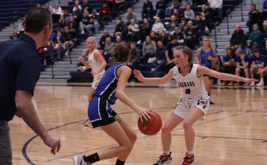 Sophomore Josie Benson guards a Gardner Edgerton player as she tries to move closer to the basket Friday, Dec. 9.