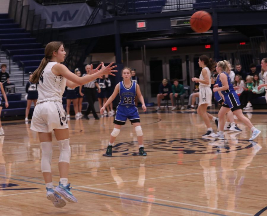 Sophomore Averie Landon reaches to catch the ball at the beginning of the next drive.