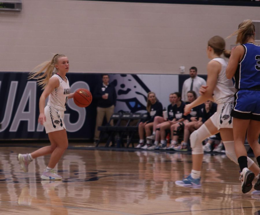 After the tip off, senior Sophie Pringle dribbles the ball down the court.
