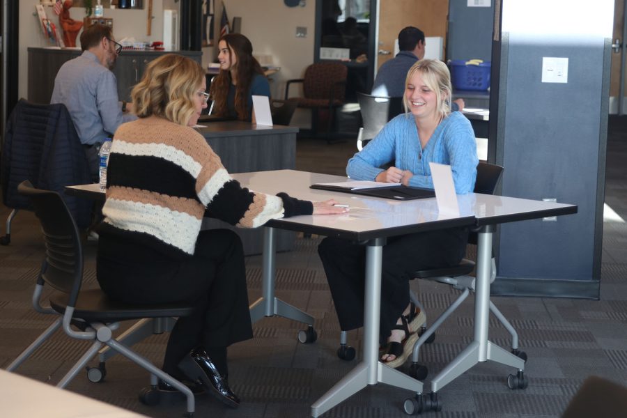 Laughing, junior Megan Kephart participates in the mock interviews with associate principal Marilyn. Chrysler. 