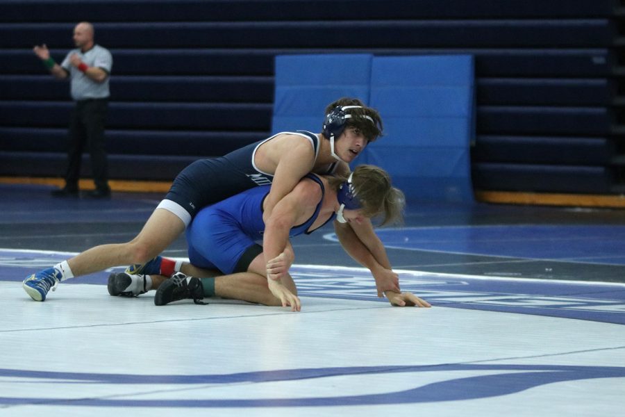 Senior Eddie Hughart fights to pin his opponent on the ground.