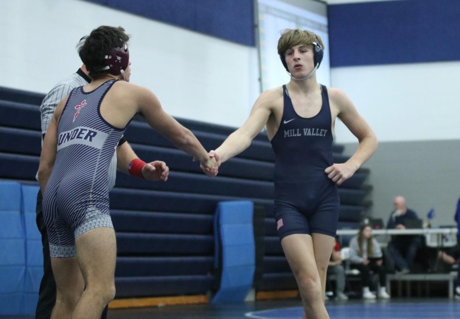 After winning the match, junior Collin McAlister shakes his opponents hand.
