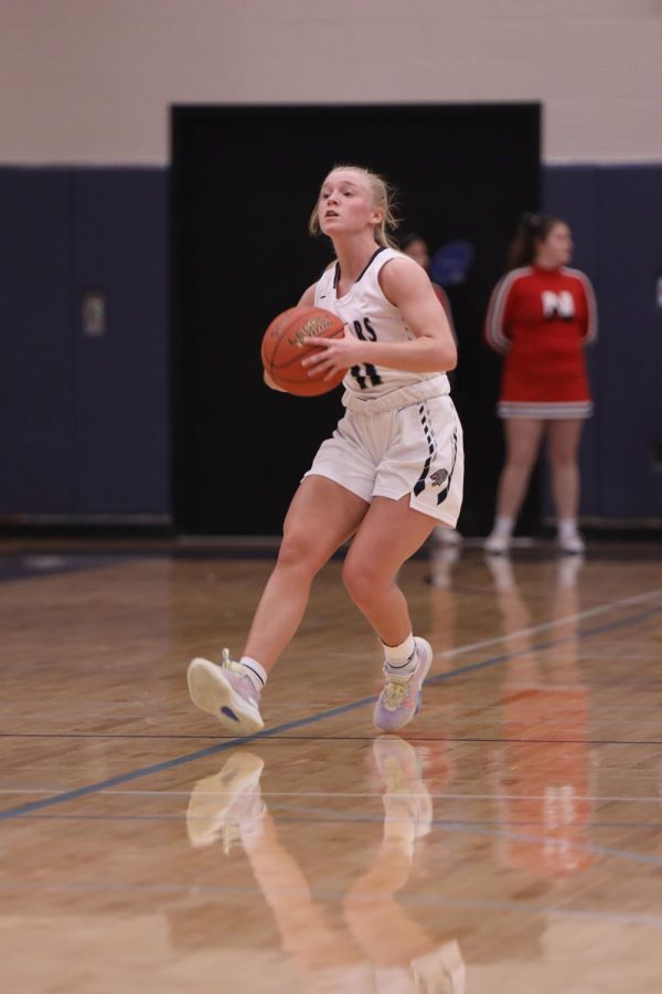 Passing to a teamate, senior Sophie Pringle looks for an opening. 