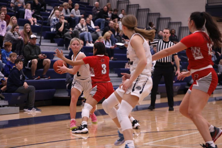 Attempting to get a pass around the defender, junior Keira Franken looks for an open teammate.