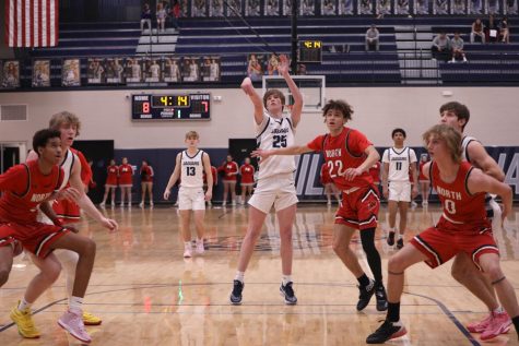 Sophomore Carter Kaifes watches his free throw shot while players fight for a possible rebound.