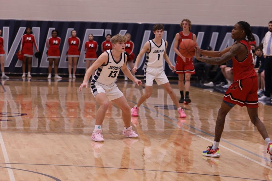 Defending against the ball carrier, junior Bryant Wiltse forces a pass.