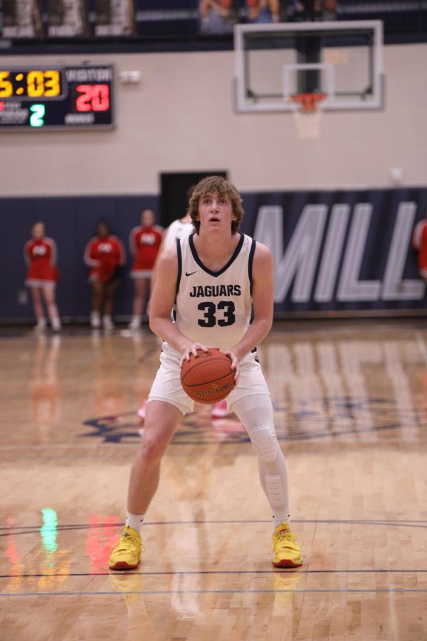 Focusing on the basket, junior Mason Kemp prepares himself for a free throw.