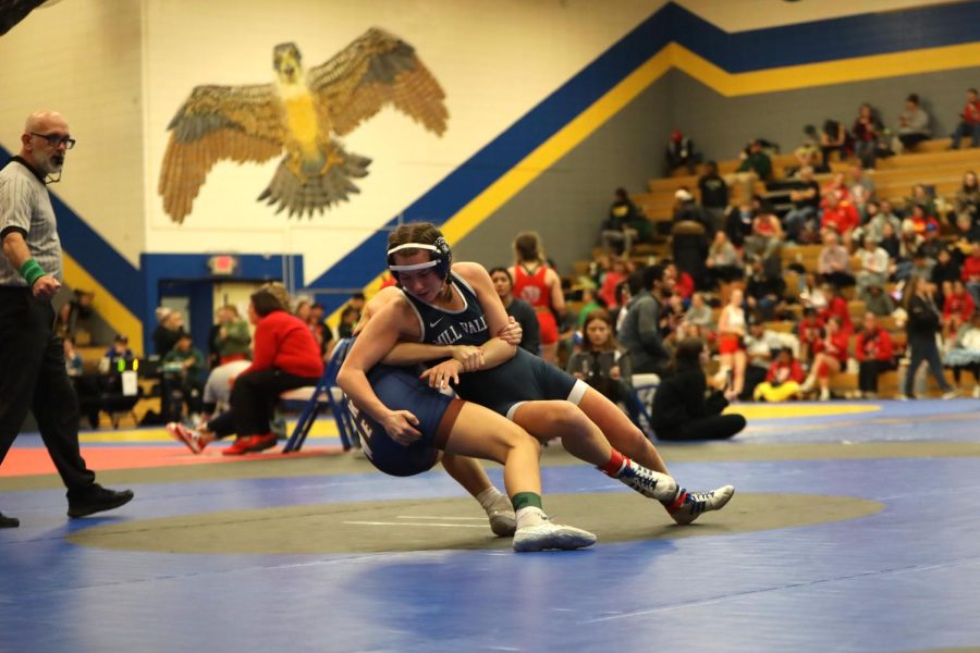 In an attempt to take down her opponent, sophomore Piper Wendler grabs her opponent.