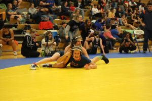 Pinning down her competition, freshman Finley Rose immobilizes her opponent.