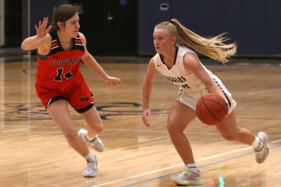 Senior Sophie Pringle dribbles down the court to make a shot.