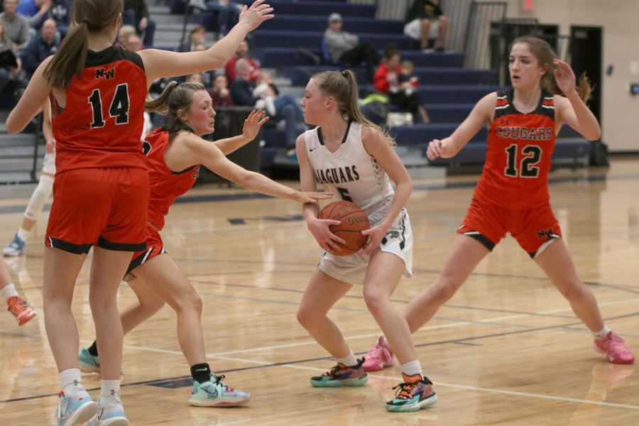 Holding on tight, sophomore Josie Benson stops the other team from getting the ball. 