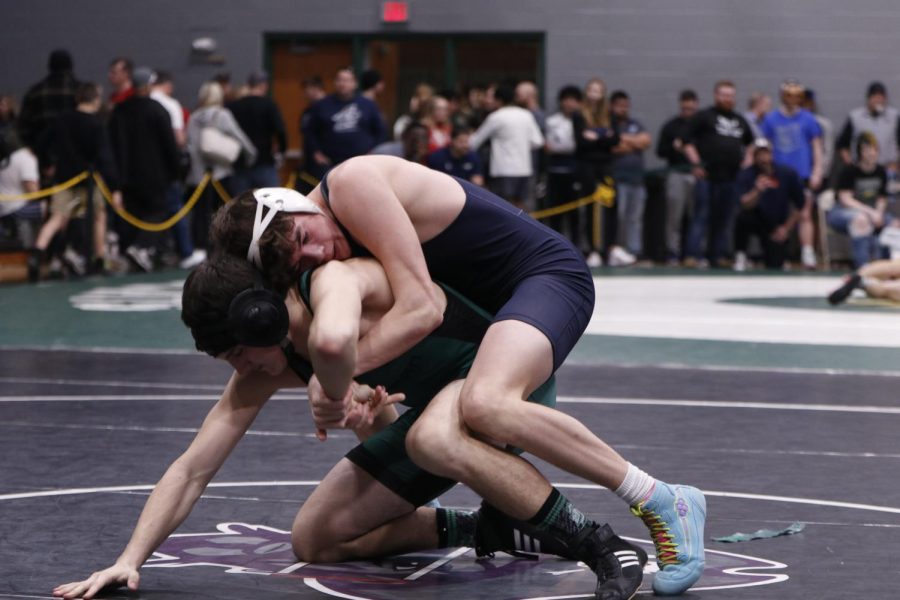 Senior Dylan Massey tries to take his opponent down, winning his match at Basehor-Linwood High School.