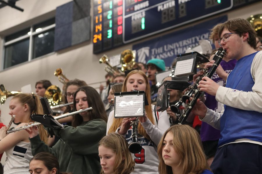 During halftime of the girls basketball game against Shawnee Mission North, freshmen Ashlyn Keim and Ian Weatherman focus play The Hey Song to entertain the crowd.  