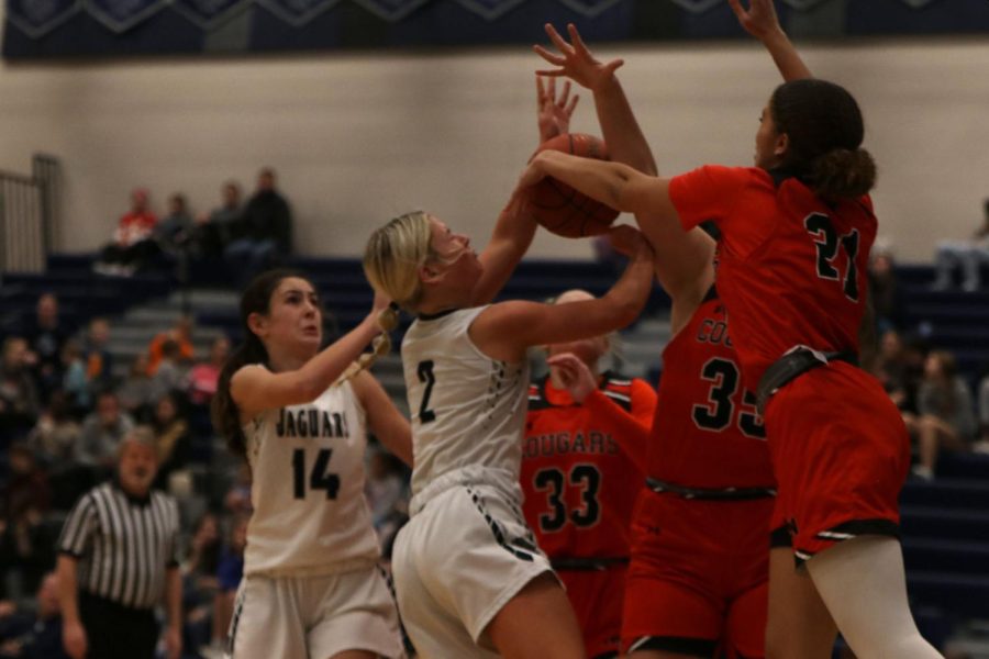 With force, junior Keira Franken pushes the ball through a wall of defenders.
