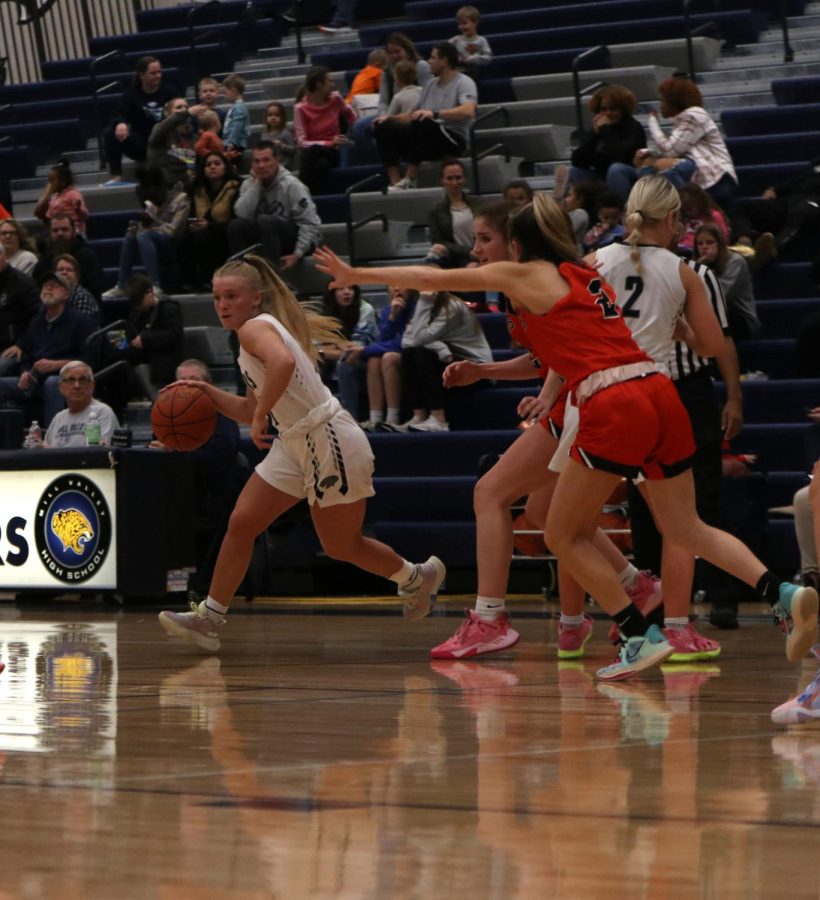 Moving around the court, senior Sophie Pringle avoids the opposing defense.