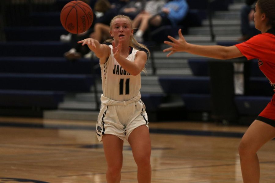 Finding a teammate, senior Sophie Pringle passes the ball.