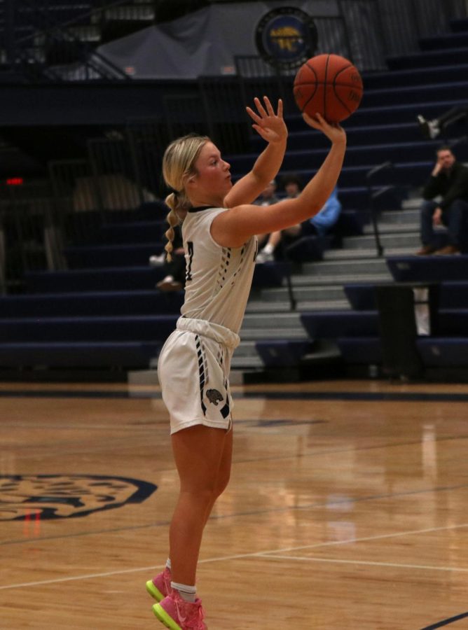 Going for a three point shot, junior Keira Franken shoots the ball.
