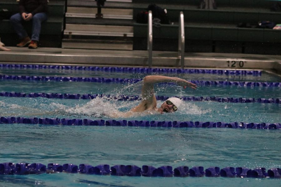 Junior Andre Arnold takes a breath in between strokes