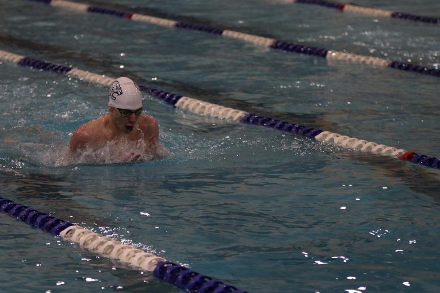 Halfway through the race, sophomore Alex Martin comes above the water for a breath.
