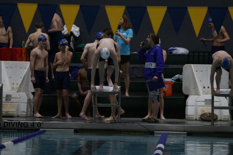 About to dive off the block, sophomore Anderson Doyle prepares himself for the race. 
