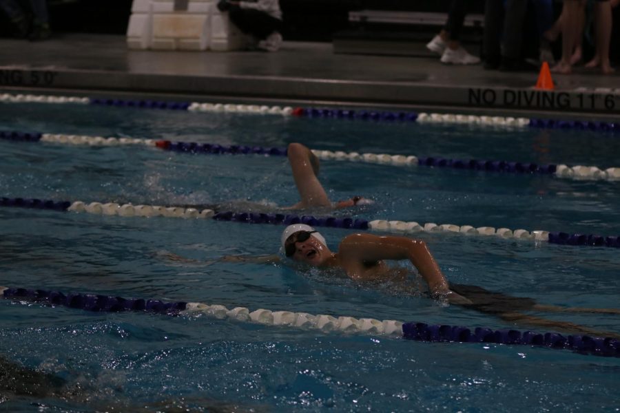  Coming up for a breath, freshman Harrison Guest finishes his race.  

