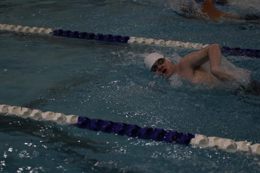Continuing his race strong, junior Carson Reynolds glides through the water. 

