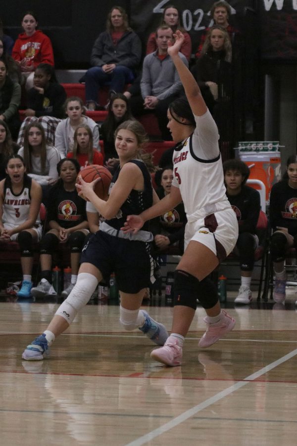 Fighting through contact, sophomore Averie Landon tries to beat her defender.
