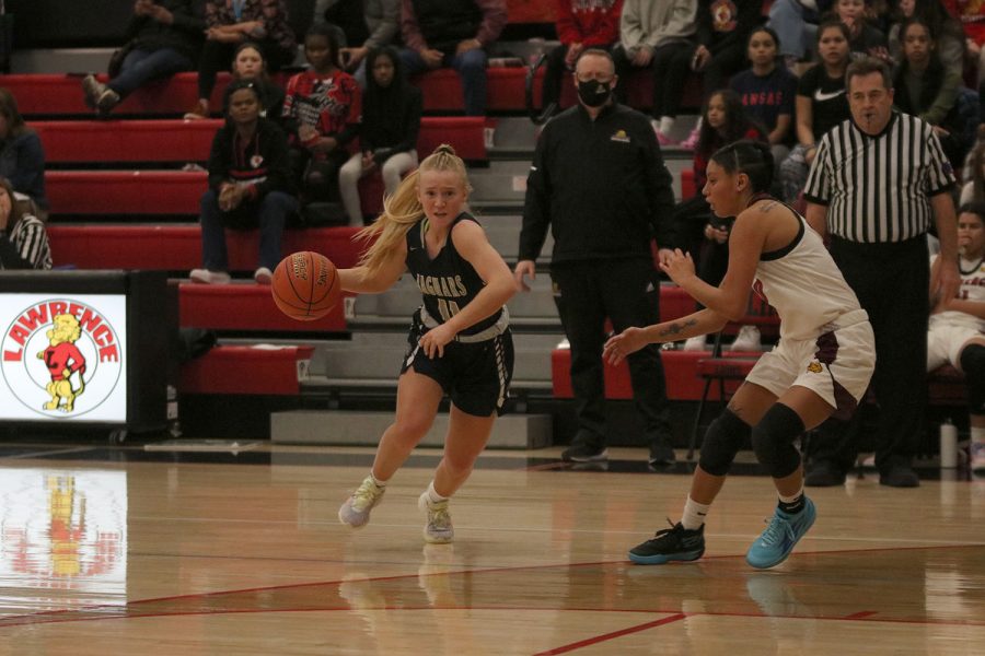 Seeing an open lane, senior Sophie Pringle drives the ball to the hoop. 
