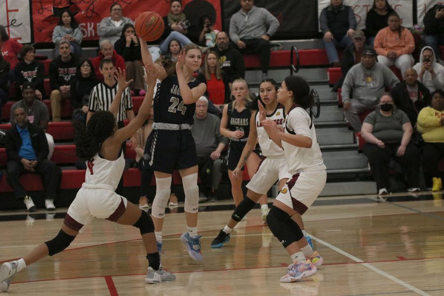 Surrounded by defenders, sophomore Averie Landon passes the ball out to the corner. 
