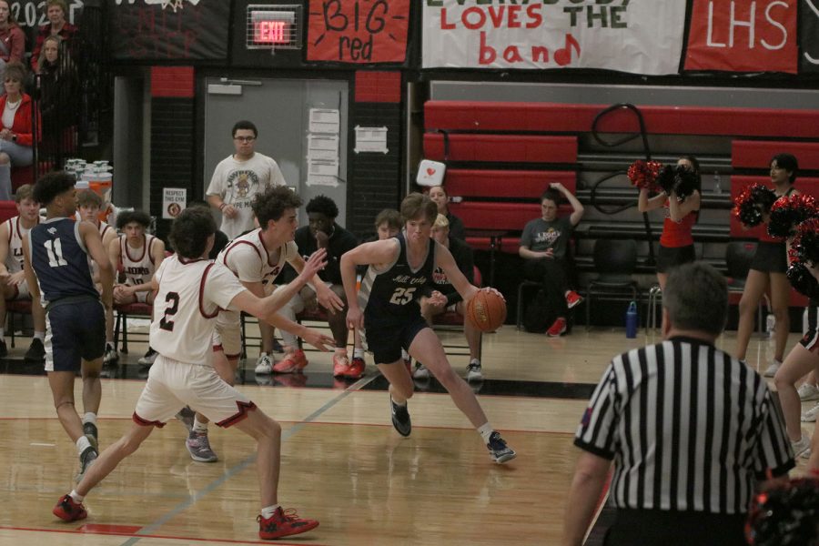 With determination, sophomore Carter Kaifes drives the basket. 
