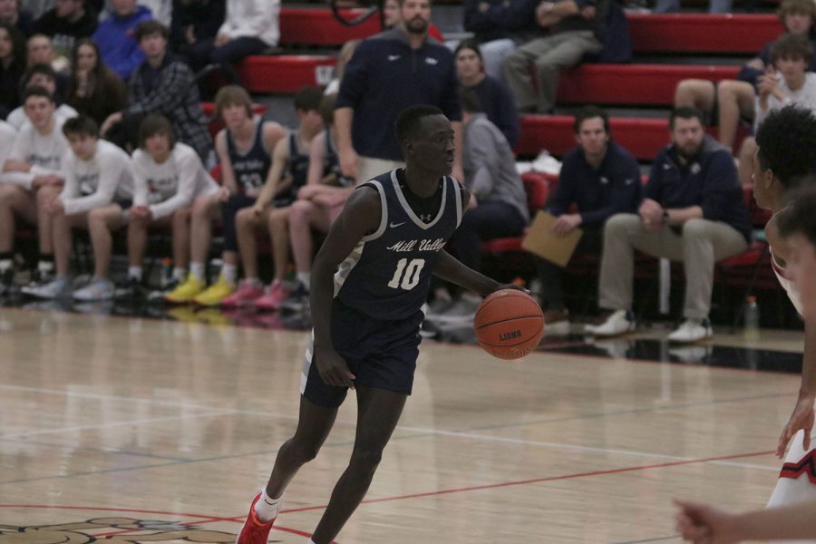 Scanning to court, senior Nen Matlock dribbles up the court. 
