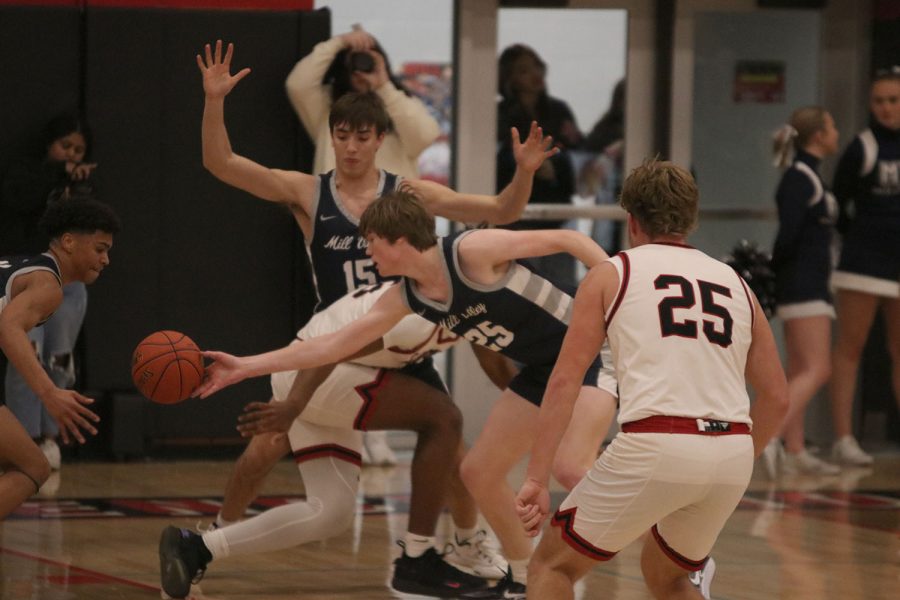 Poking the ball away, sophomore Carter Kaifes works with his teammates to get a steal. 
