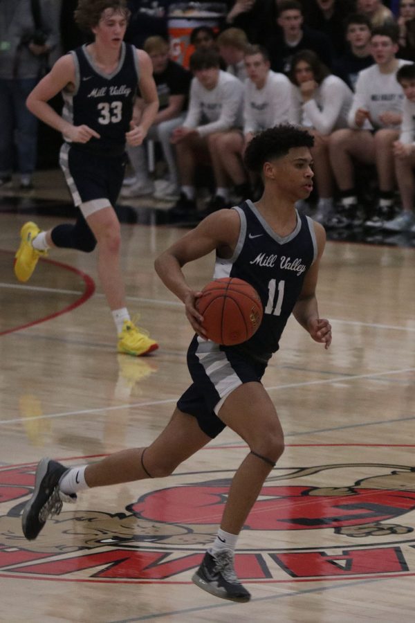 Using his speed, senior Jameson Fisher weaves down the court. 
