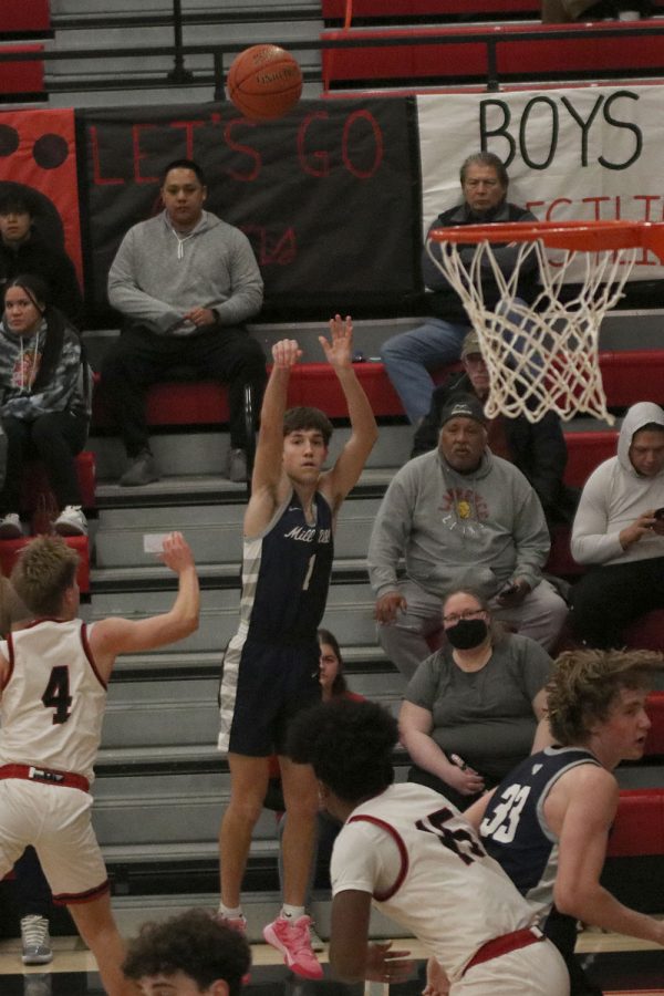 With the flick of his wrist, senior Brooks Jahnke makes a three-pointer. 
