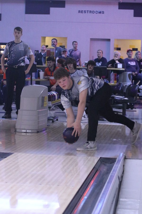 Getting ready to let go of the ball, junior Austin Leiker aims for a strike.