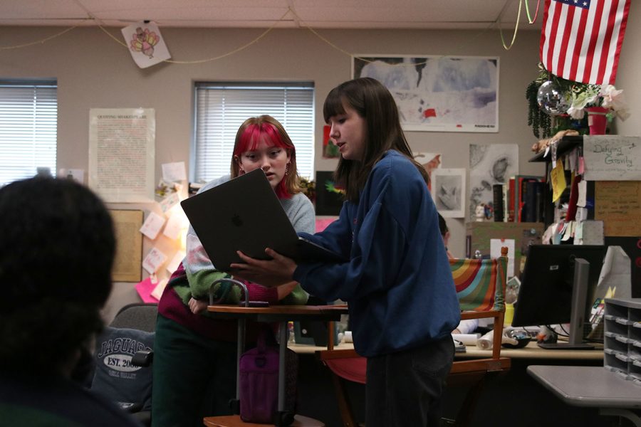 Co-presidents senior Sarah Johnston and junior Emma Clement discuss the Model UN meeting objectives as students come in to the clubs first meeting Tuesday, Jan. 10. 