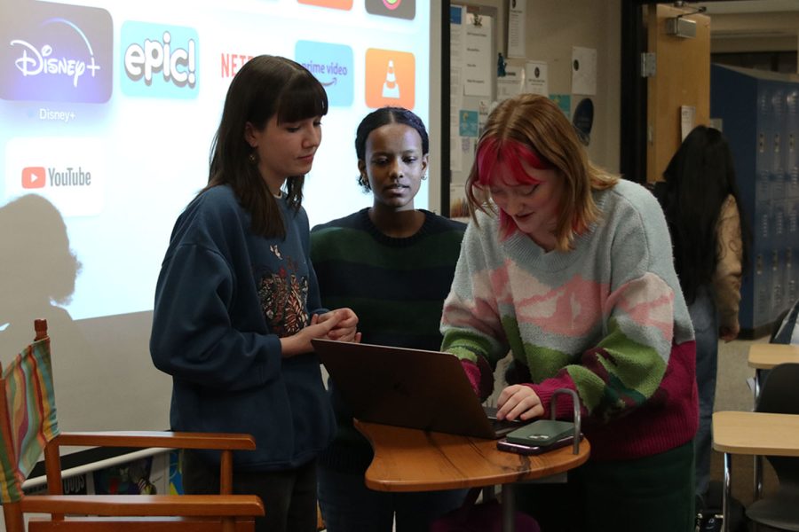 Co-presidents senior Sarah Johnston and junior Emma Clement discuss with junior Meron Abebe after the meeting ends Tuesday, Jan. 10. 